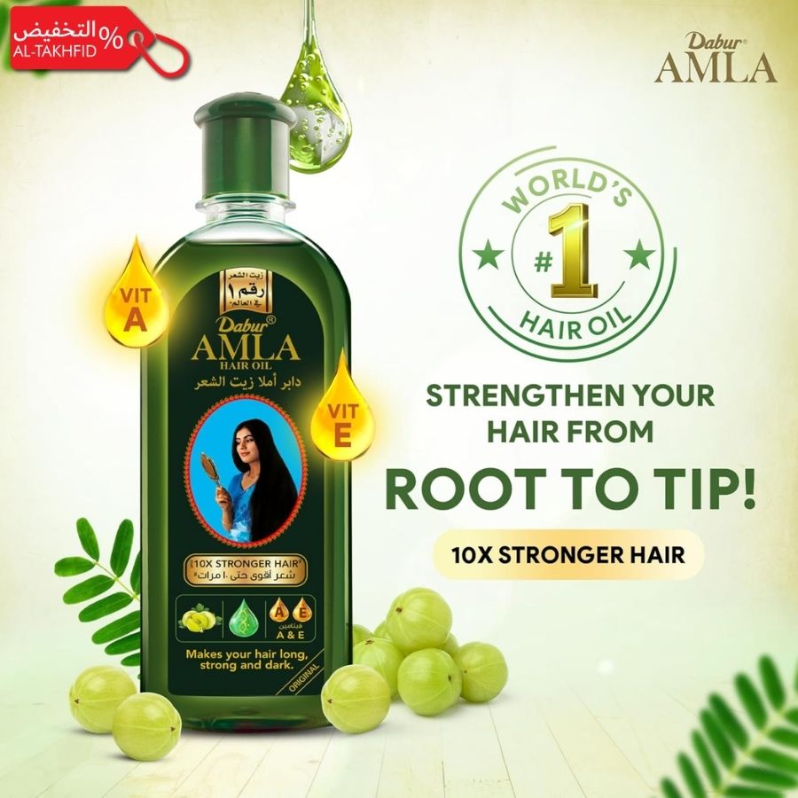 Dabur Amla hair oil bottle with green leaves and a woman's face on a light background