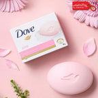 Dove pink soap bar and packaging on a pink background with flowers.