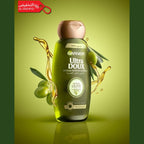 Garnier Ultra Doux shampoo bottle with olive leaves and oil on a green background