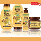 Garnier Ultra Doux hair care products on a reflective surface with a promotional tag in the corner.