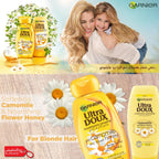 Garnier Ultra Doux shampoo and conditioner bottles with a woman and child, camomile flowers, and promotional text.