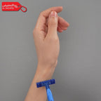 Hand holding a blue razor against a gray background with a red promotional tag in the corner.