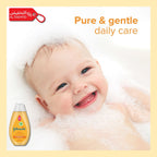 Baby in bubbles with Johnson's Baby bottle, text 'Pure & gentle daily care' on a yellow background