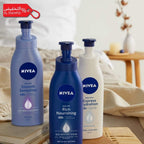 Three Nivea body lotion bottles on a wooden surface with a blurred background