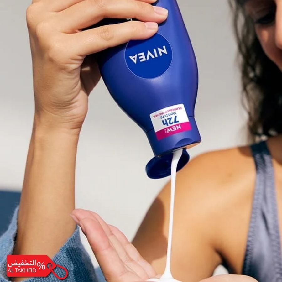 Person applying Nivea lotion to their arm with a white background