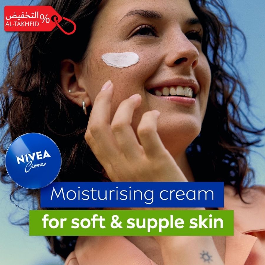 Woman applying Nivea moisturizing cream on her face with a blue background