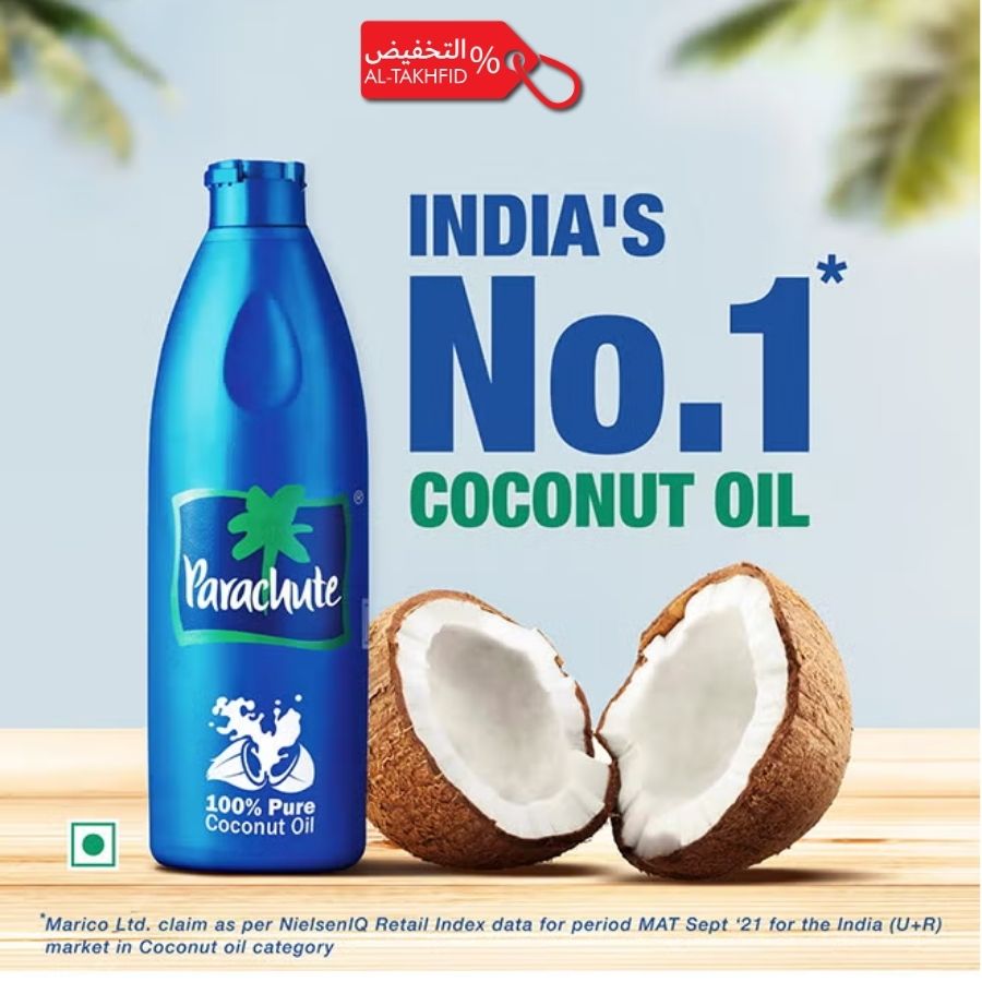 Parachute coconut oil bottle with coconuts on a wooden surface, against a light blue background