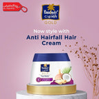 Parachute Gold Anti Hairfall Hair Cream container on a pink background