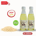 Two bottles of camel sesame oil with sesame seeds and promotional text on a white background