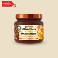 Garnier UltraDoux Hair Remedy jar on a beige background