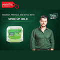 Vatika Menz hair product with a man in a green shirt on a dark green background