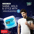 Vatika Menz hair product advertisement with a man and product packaging on a dark blue background.