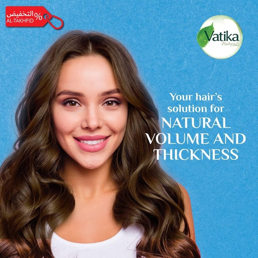 Woman with long, wavy hair against a blue background with Vatika hair care product branding.