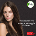 Woman with long brown hair against a dark background with Vatika logo and text.