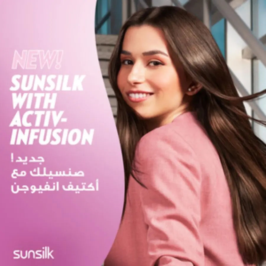 Woman with long hair smiling, Sunsilk advertisement on a pink background