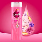 Sunsilk shampoo bottle with floral and droplet design on a pink background